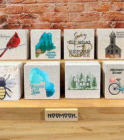 Coaster Display 12 designs, coaster merchandiser against brick wall