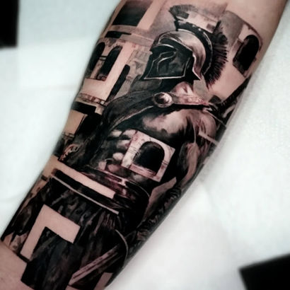 Black and grey contemporary style tattoo of a gladiator wearing a helmet. The style is partially pixelated with fragments flying around the main focus