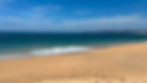 Playa de arena, olas del mar, cielo azul en Paraíso Yoliztli