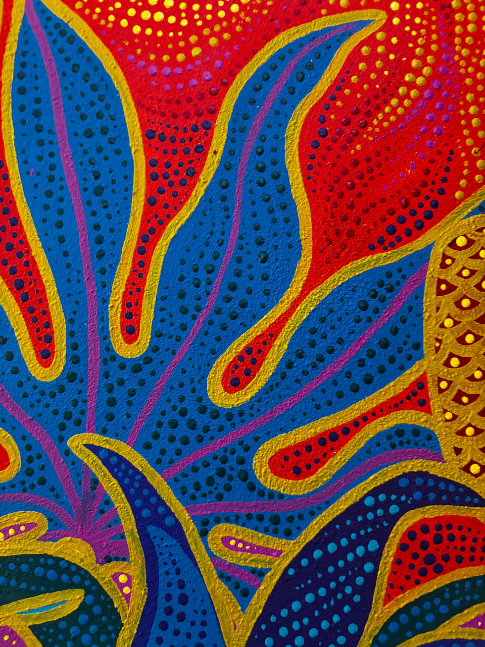 a close up of a colorful painting on a blue background