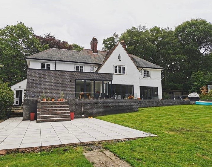 Rear house extension on a family home in Wirral with elevated patio and garden view