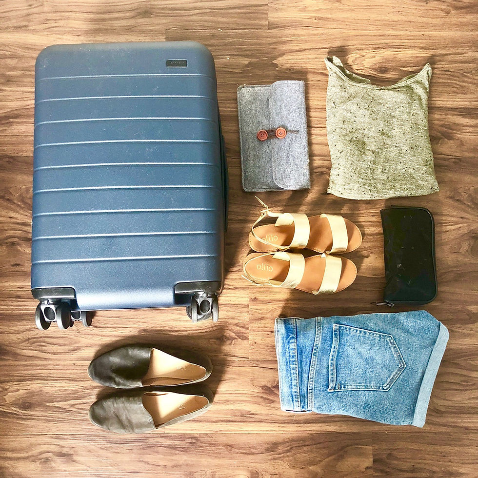 Some of my packing essentials - my Away bag, comfy shoes, iPad, chargers, and neutral-colored clothing.