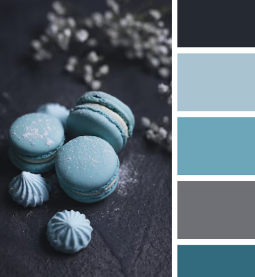 Blue macarons and meringues on a dark surface with baby's breath flowers. Color palette on the right shows shades of blue and gray.