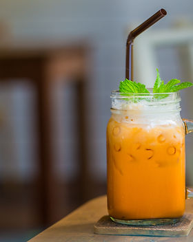 milk thai tea in glass mugs on wood tabl