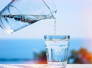 Purified water is poured from a glass ju