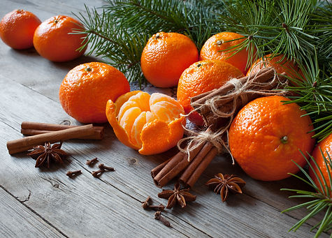 Tangerines on a wooden table with branch
