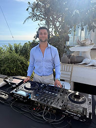 Adrian DJing by the coast