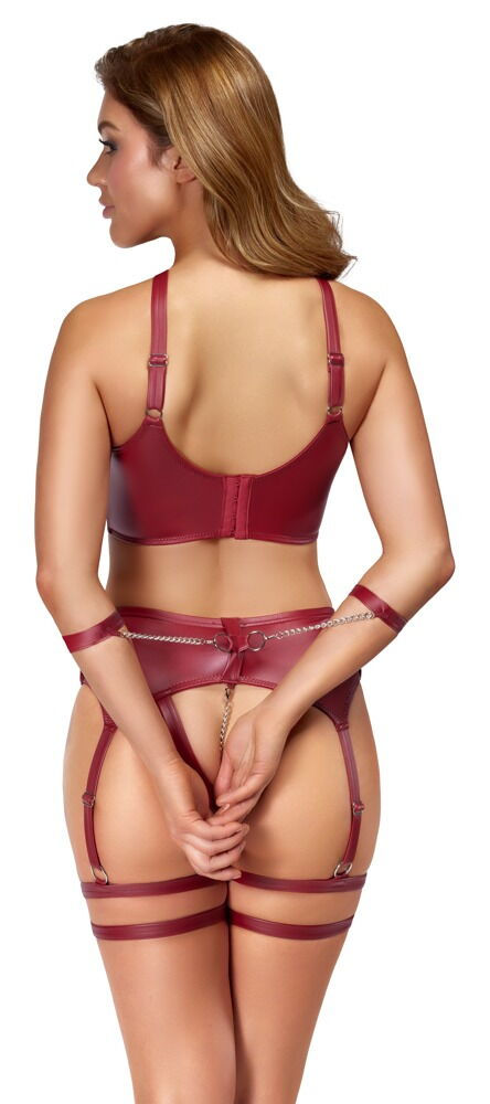 Thumbnail: Frau in dunkelrotem Bondage Dessous Set. Hände hinter ouvert Straps-String gefesselt. Intimkette. Rückansicht