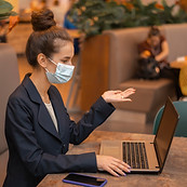 side-view-businesswoman-with-medical-mask-working-her-laptop.