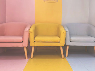 A brightly colored room with three chair