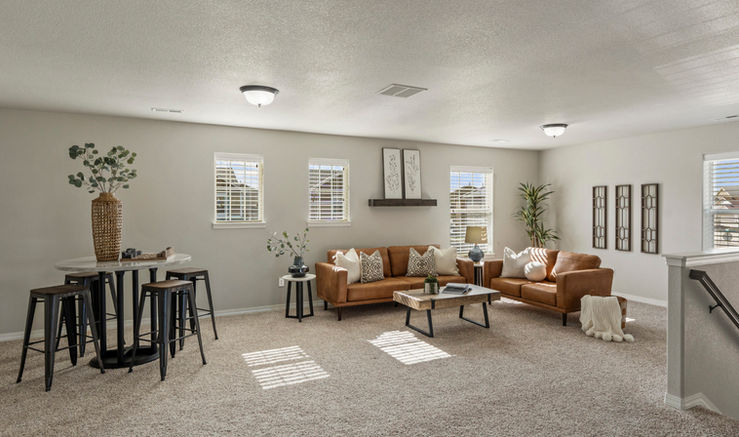 Staged loft with separate zones for TV lounging and gaming, showing furniture layout ideas and room versatility.
