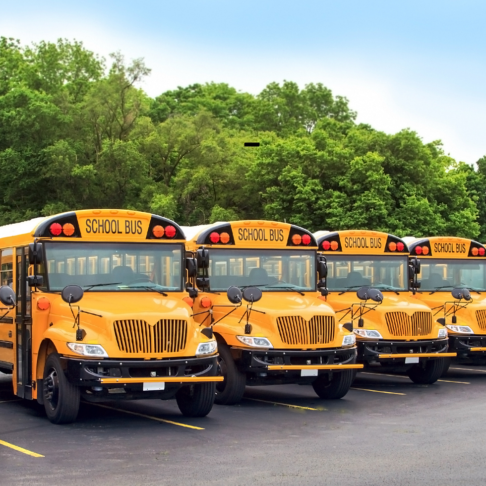 Yellow school buses lined up in a parking lot, a reminder to start your Des Moines home search before the school year begins.