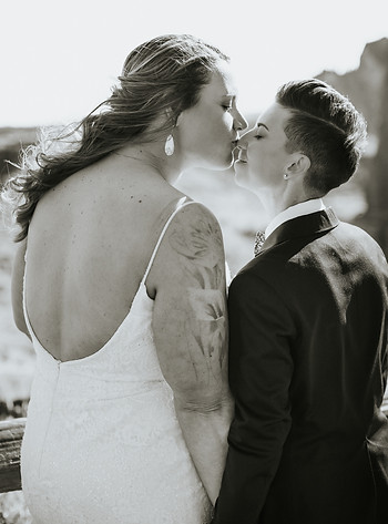 LGBTQ+ couple shares intimate moment in soft black and white lighting