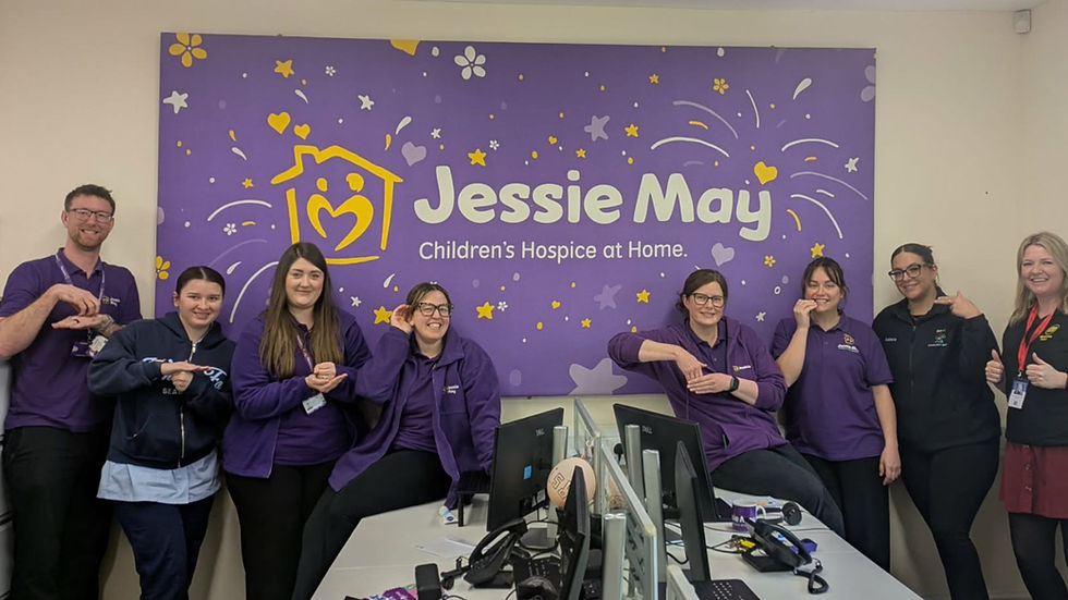 The team from the Jessie May Trust signing their favourite signs from the morning's training.