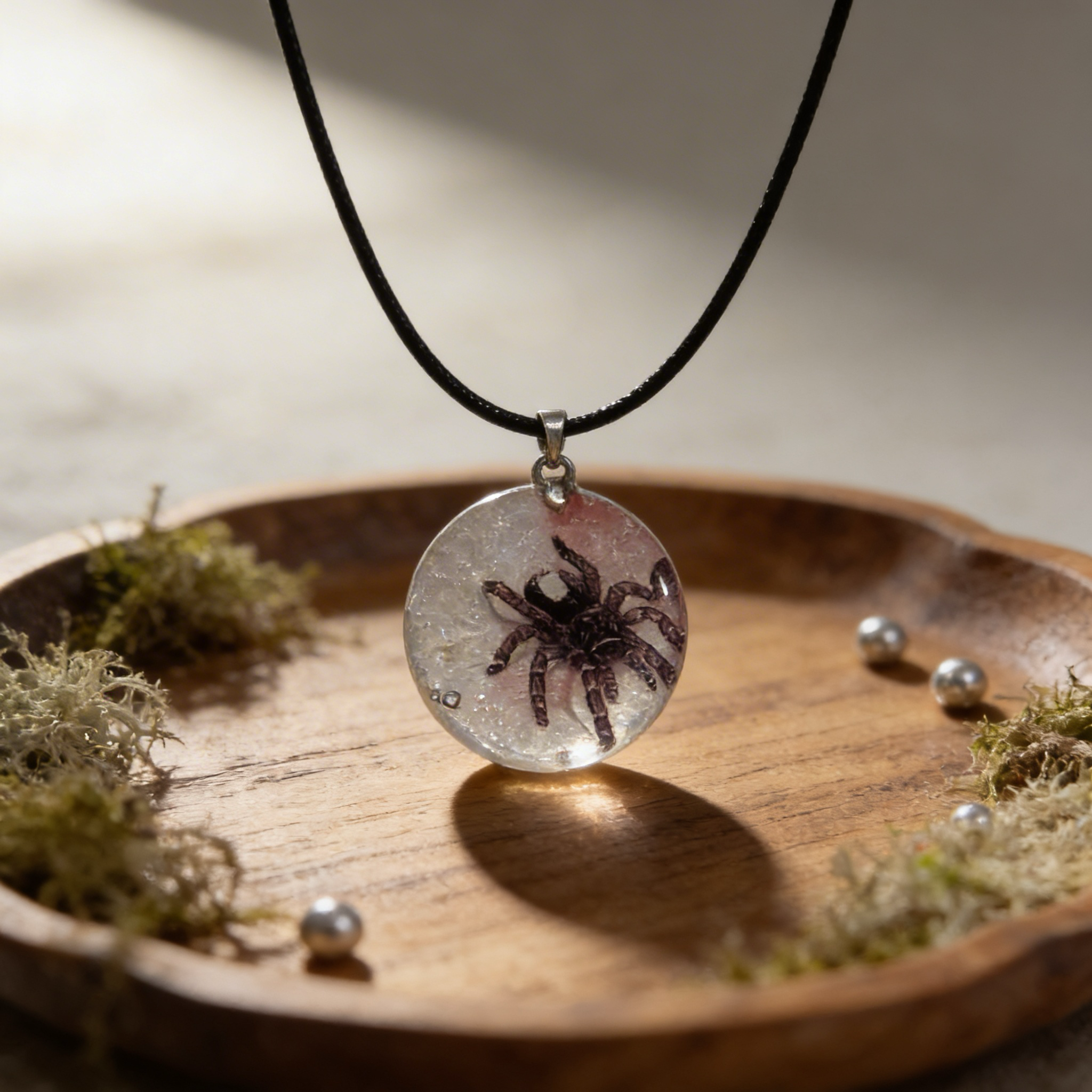 Unique tarantula resin pendant necklace on black cord. Handmade statement jewelry for spider and nature lovers.