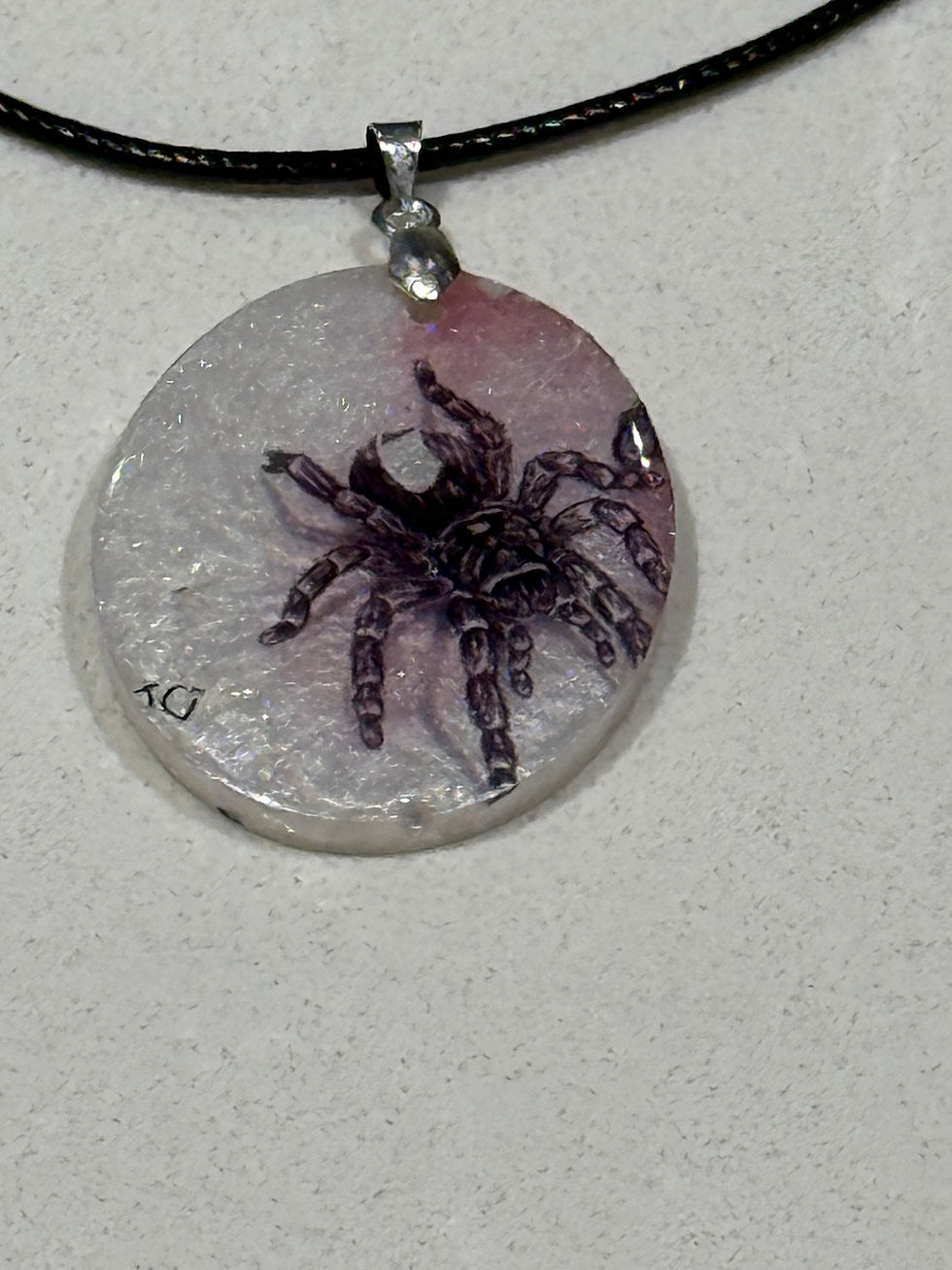 Thumbnail: Close-up of round resin pendant with detailed tarantula design showing texture and shimmer effect