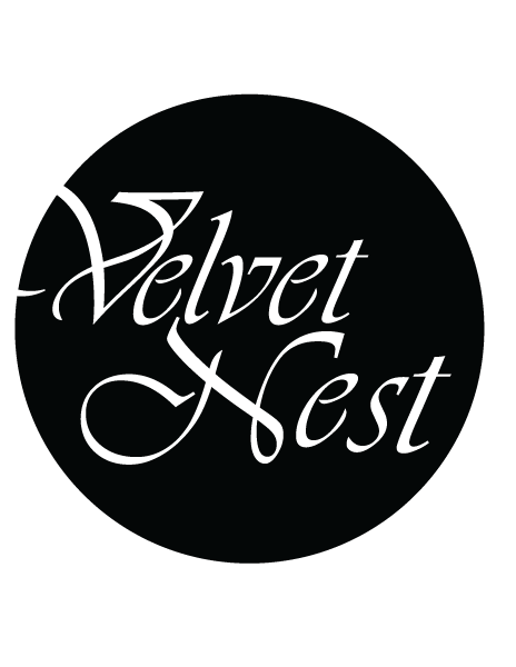 Velvet Nest logo in a circular black design with elegant script typography.