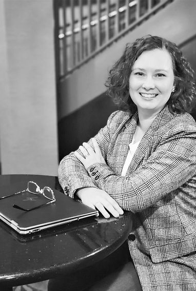 Owner of Balanced Accounting LLC, a small business accountant, smiling in a professional office setting.