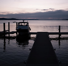 a jetty for boats at a grey and purple s