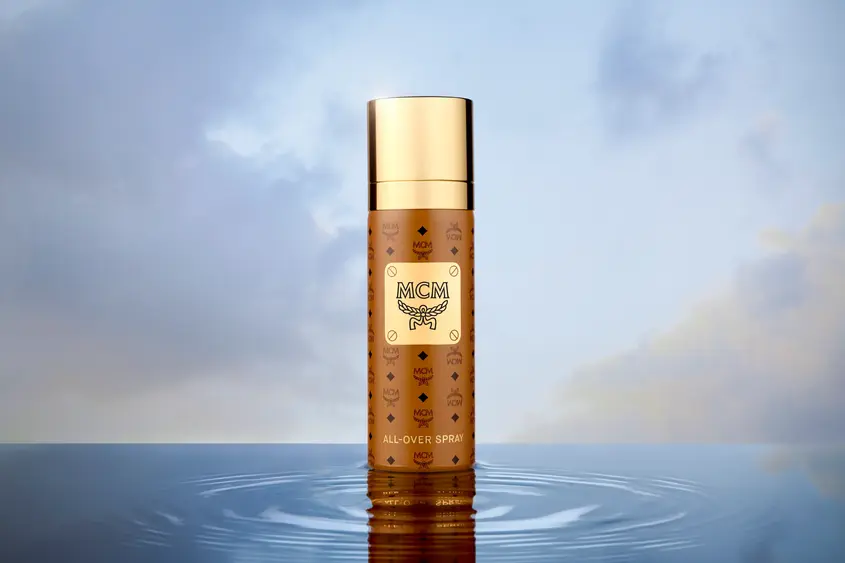 Luxury skincare bottle photographed with reflective water lighting for commercial beauty campaign