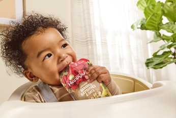 Baby drinking pouch photographed in commercial lifestyle campaign