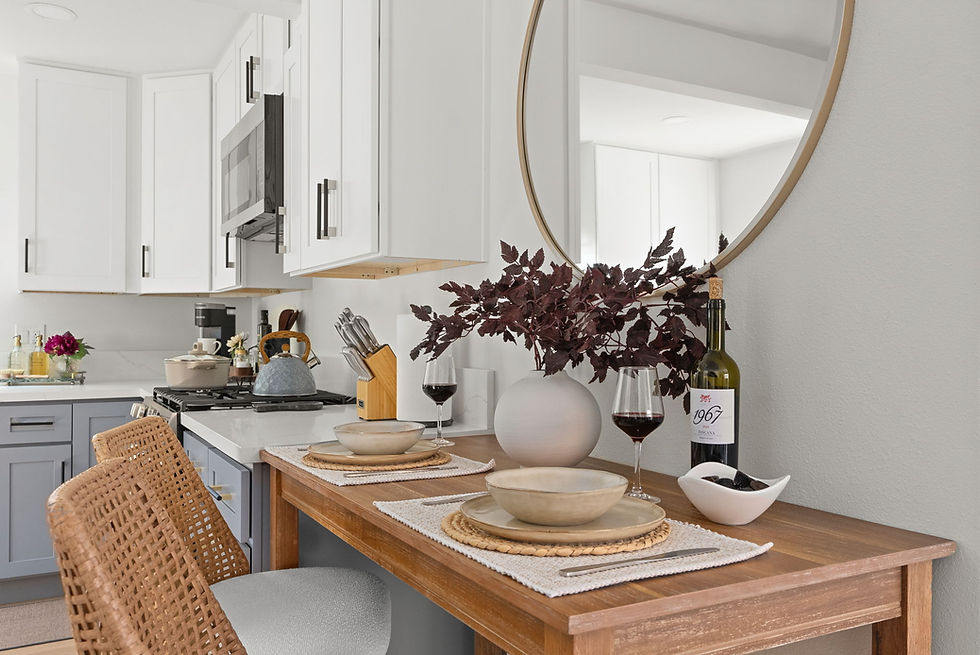 Kitchen dining nook staged with wine and place settings for two Airbnb guests