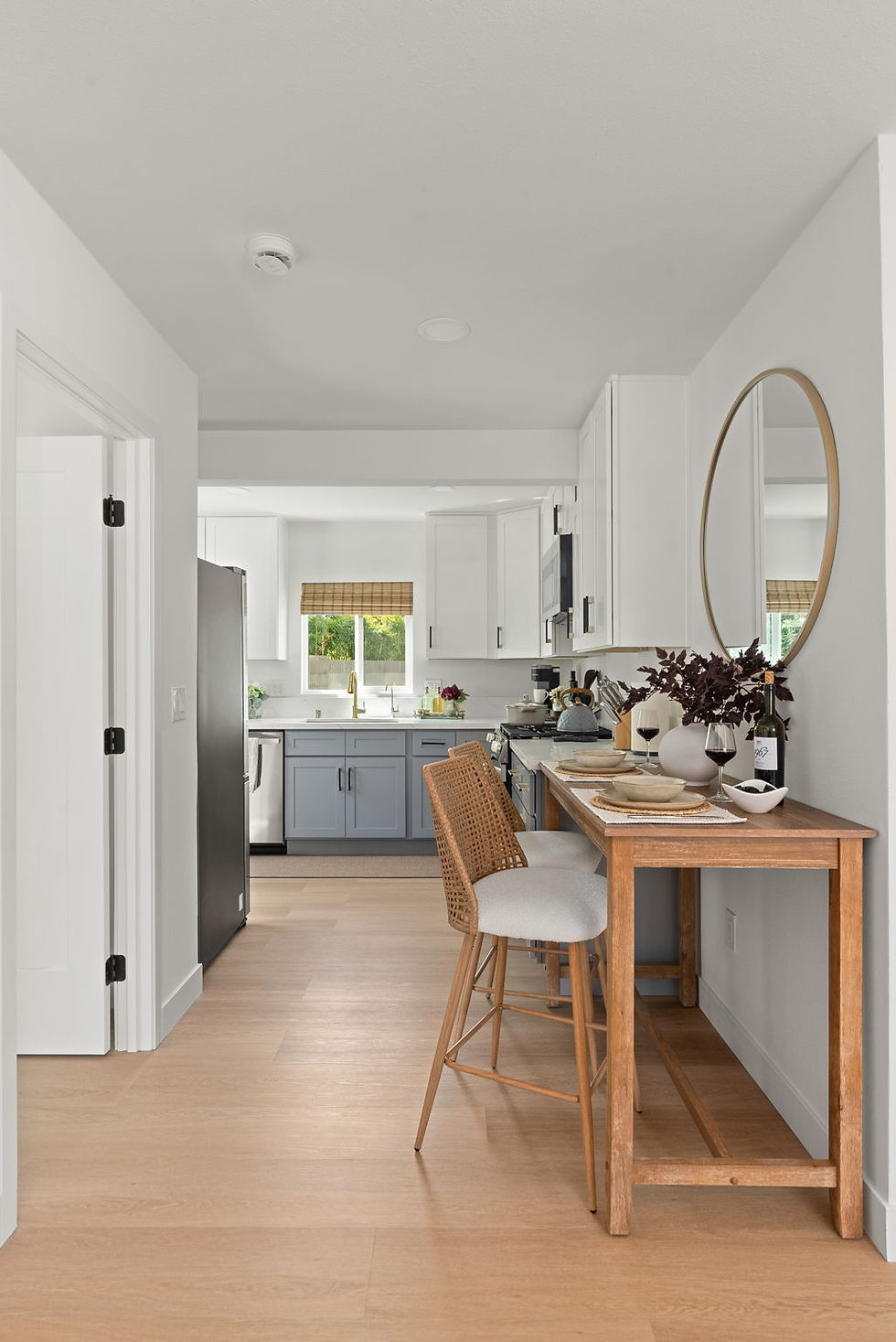 Entry hallway with a wood console table and a view into the kitchen
