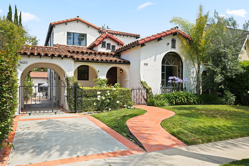 Remodeled 1932 Spanish Colonial Revival at 1618 S Durango Avenue with white stucco, red tile roof, arched entry and landscaped front yard