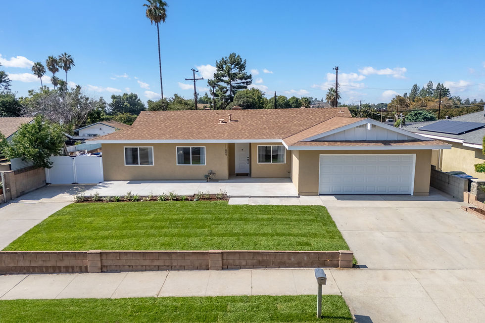 Single-story ranch-style home with attached garage and raised front lawn at 11609 Garrick Ave in Los Angeles