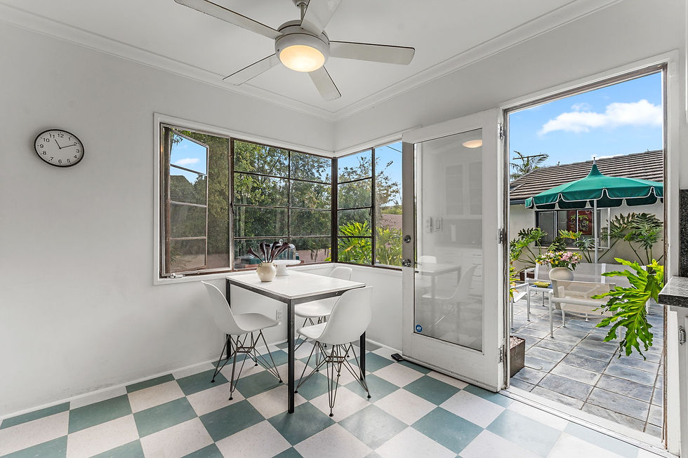 Breakfast nook with checkerboard tile flooring, round dining table and glass door opening to the backyard