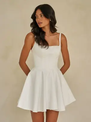 Crafted in luxurious satin, this sweet mini wedding dress is perfect for the minimalist bride. But who also wants timeless elegance with a fashion-forward edge.

Featuring a structured corset bodice with exposed boning, a clean square neckline, and a flattering Basque waistline. Waverly-Mae sculpts the figure for a cinched, tailored silhouette that feels both polished and playful.

Designed for versatility, this style invites personalisation—pair it with the Waverly-Mae satin overskirt for a striking contrast of textures. Or, mix and match with veils and accessories to create a bridal look that’s uniquely your own.

From ceremony to celebration, Waverly-Mae is a statement mini with endless styling possibilities.