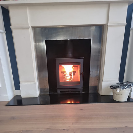 White wooden fireplace with stainless steel inner design