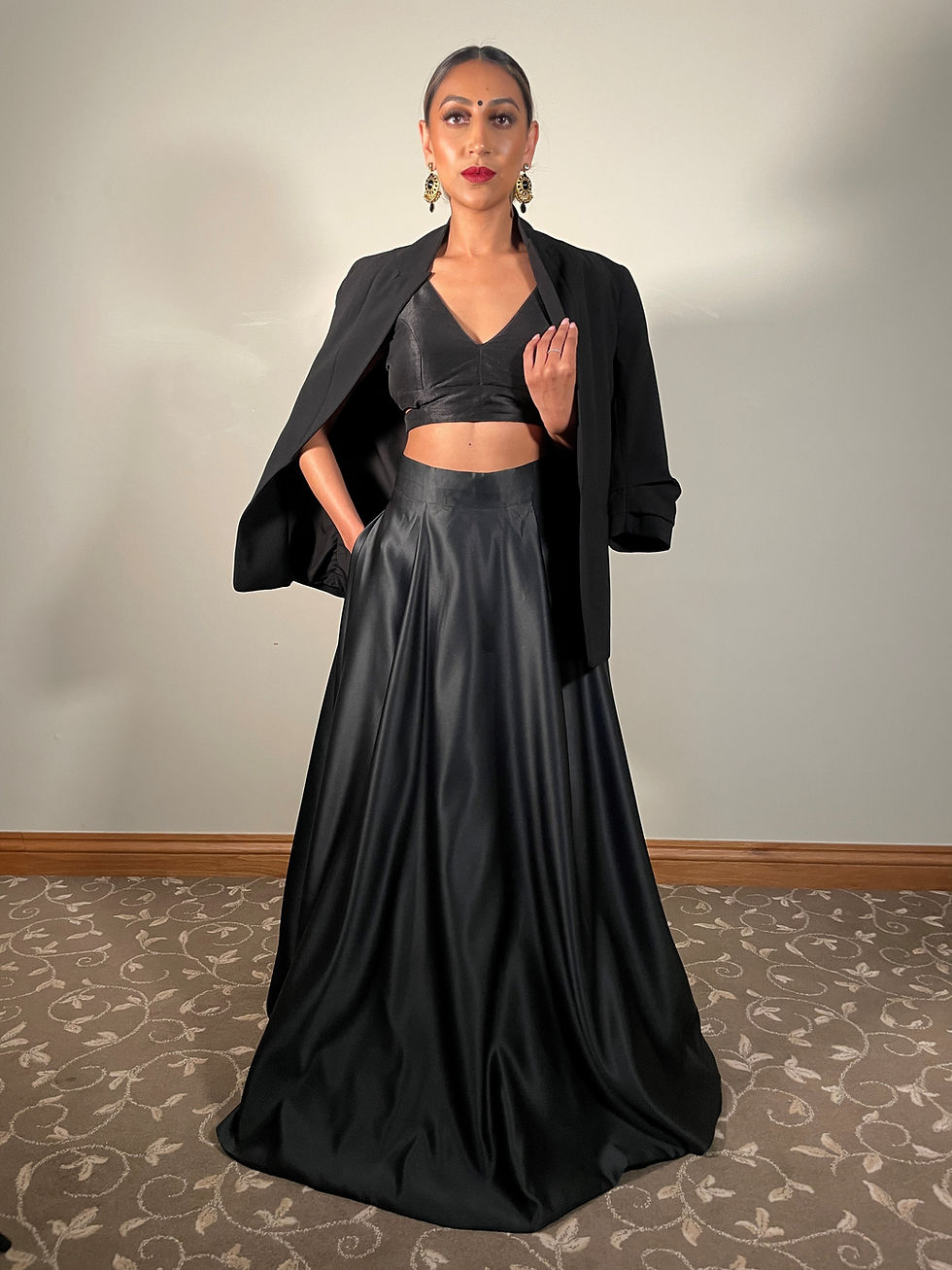 Thumbnail: Woman in black satin skirt with pockets and matching blazer