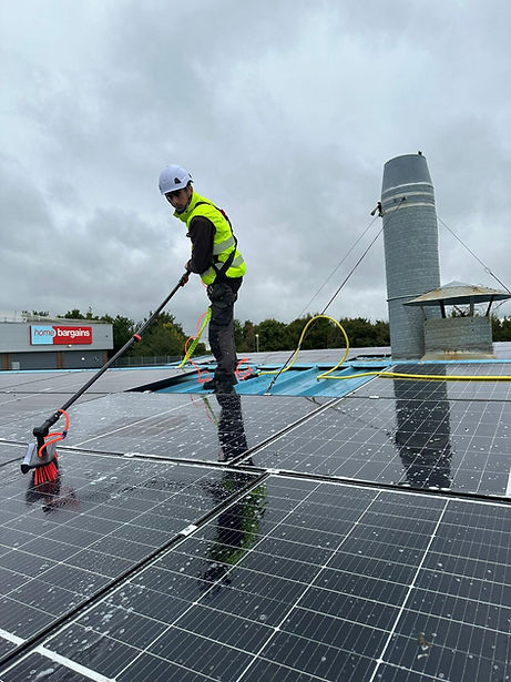 A service professional performing solar power maintenance in a building.