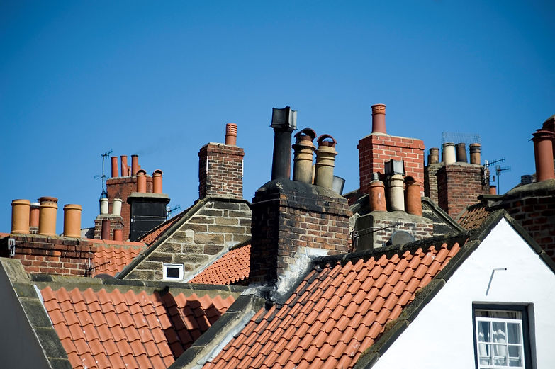 Chimney installation done on a residential building’s chimney outdoors.