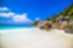 beach-surrounded-by-sea-greenery-sunlight-blue-sky-praslin-seychelles (1).jpg