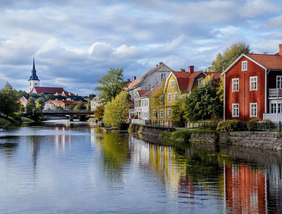 Colourful wooden houses by a lake in Gävleborg, Sweden