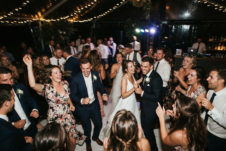Guests celebrating together on the wedding reception dance floor