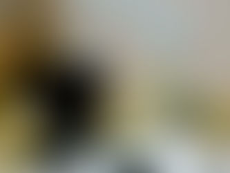 A messy desk covered n scrunched up paper.