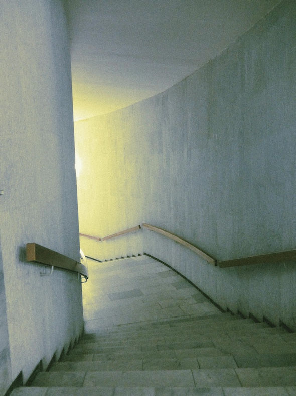 An empty stairwell with whitewashed walls.