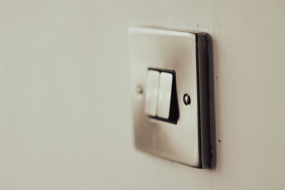 A silver light switch on a wall