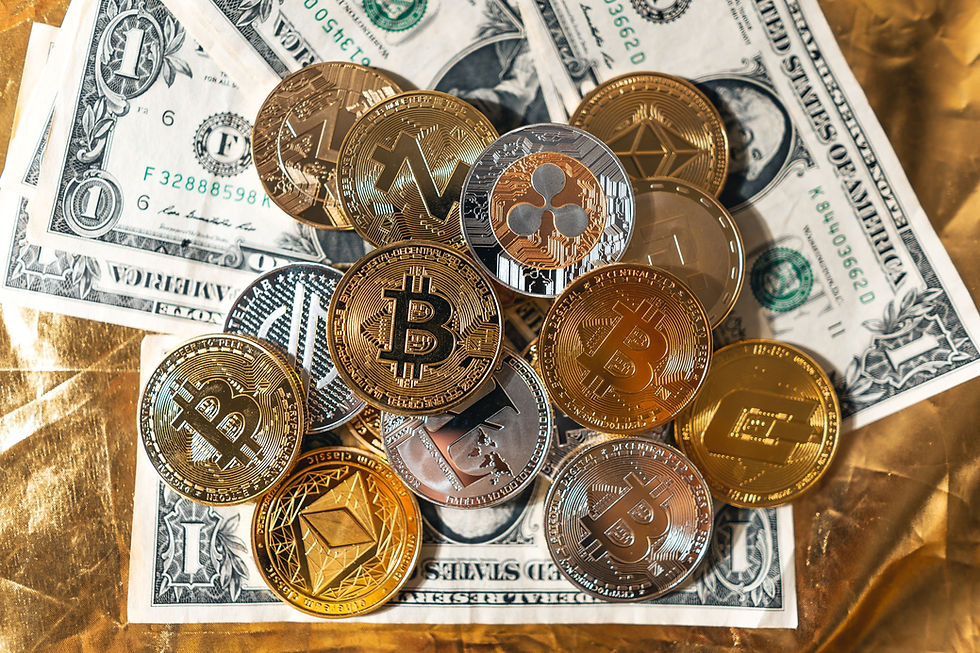 Cyptocurrency coins spread out over dollar bills