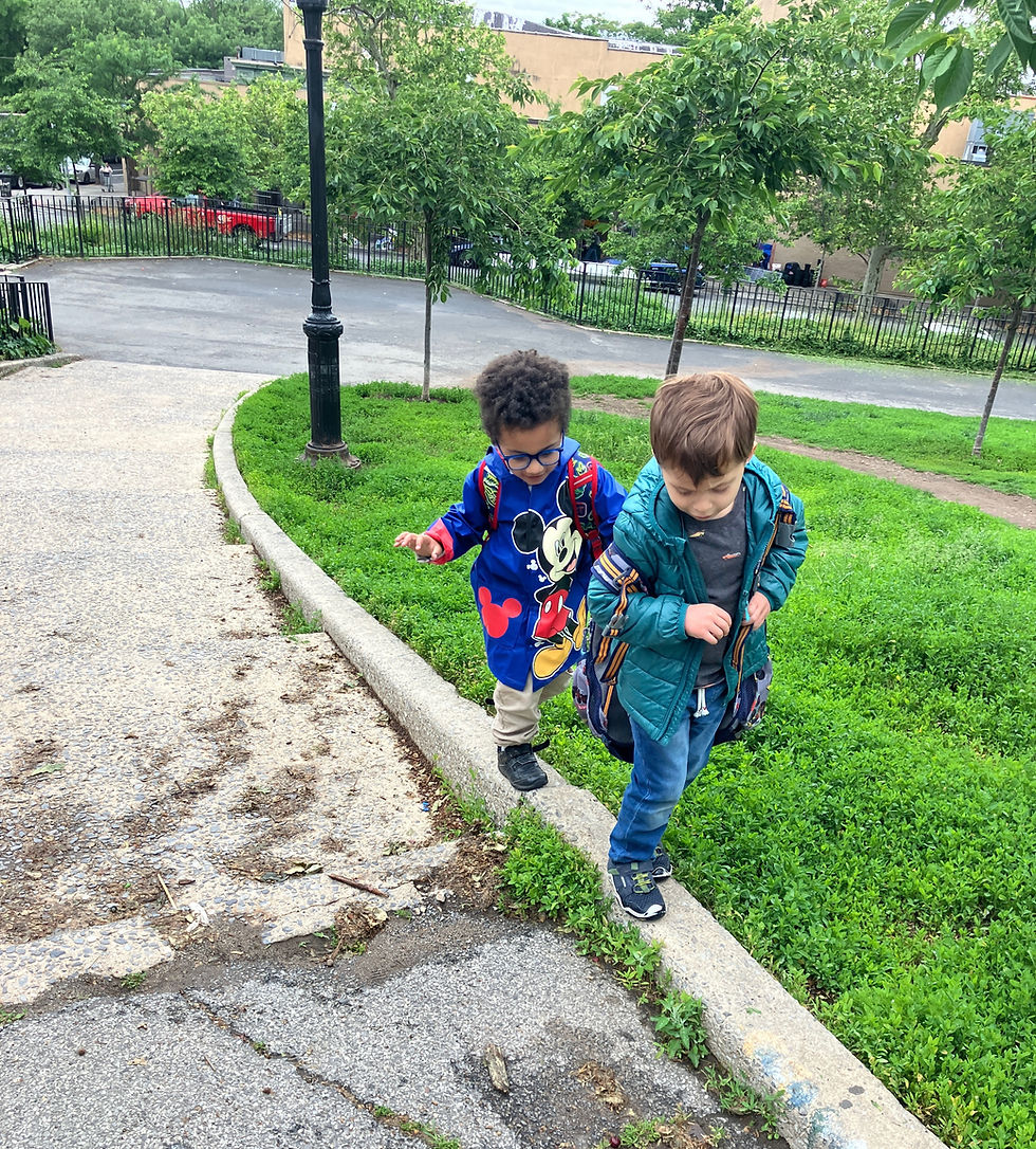 Two boys balancing on a curb