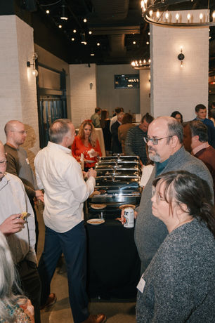 People standing around talking during company party on The Peak