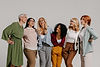 multiethnic-group-happy-mature-women-embracing-against-grey-background.jpg