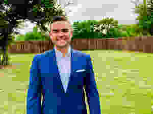 Oscar Ocuto wearing blue suit.
