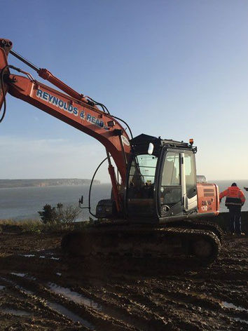 Excavator with sea in background