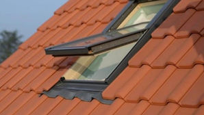 Open folding skylight on tiled roof