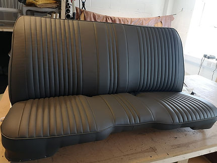 Black leather vehicle seat with ribbed trim