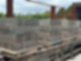 Stacks of concrete blocks on rolling pallets